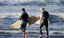 Two Surfers walking into the sea