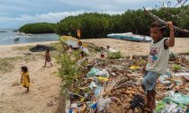 Children play by a dumping area in Bohol, Philippines