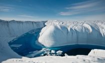 A stream of meltwater carves through Greenland's ice sheet, part of what researchers say is an accelerating rate of ice loss globally. Photo by Ian Joughin/Leeds University